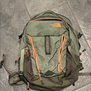 The North Face Green and Orange Surge Backpack